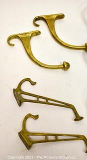 Eight (8) Aluminum and Brass Wall Hooks. Various Lengths.