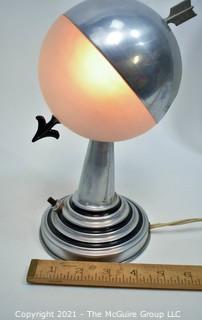 Art Deco Aluminum Globe Hemisphere “Saturn” Swiveling Table Lamp With Brass Arrow Details. Measures: 6"Wide X 6.5" Deep X 9.5" Tall. 