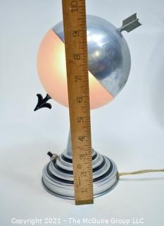 Art Deco Aluminum Globe Hemisphere “Saturn” Swiveling Table Lamp With Brass Arrow Details. Measures: 6"Wide X 6.5" Deep X 9.5" Tall. 