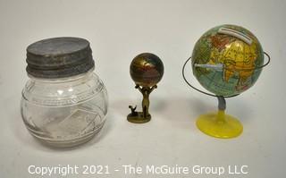 Three (3) Decorative Globe Items Includes Glass Jar, Decorative Figurine and Metal Bank. 