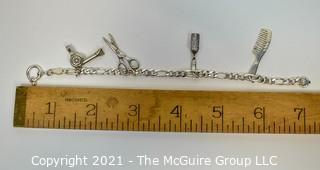 Sterling Silver Link Bracelet with Four Beauty Salon Themed Charms.  Marked Sterling.  Measures 7" long.