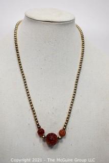 Sterling Silver and Carved Carnelian Bead Necklace on Sterling Chain. Measures 24" long.