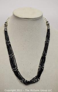 Multi Strand French Jet and Clear Crystal Bead Necklace with Silver Tone Clasp.  Measures 24" long.