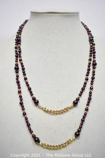 Garnet Bead Necklace with Clasp and Gold Tone Bead Spacers and Chain.  Measures 48" long