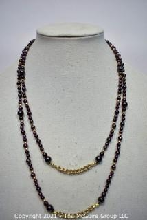 Garnet Bead Necklace with Clasp and Gold Tone Bead Spacers and Chain.  Measures 48" long