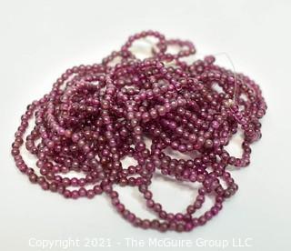 Strand of 2 mm Garnet Seed Beads.  Measures 69" long.