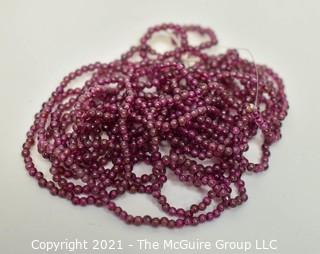 Strand of 2 mm Garnet Seed Beads.  Measures 69" long.