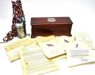 Vintage 1945 Ship Christening Bottle in Presentation Box for the USS Donner.  Bottle is contained in silver case and wrapped in silk ribbons.  Box includes programs and letters from the commissioning ceremony.  