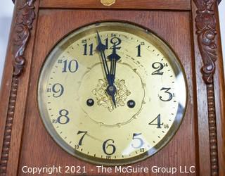 Antique Pendulum Wall Clock in Wood Case with Leaded Glass Made in Western Europe, circa early 1900's.  Measures 12" W x 31" L. 