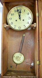 Antique Pendulum Wall Clock in Wood Case with Leaded Glass Made in Western Europe, circa early 1900's.  Measures 12" W x 31" L. 