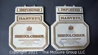 Two (2) Vintage Cast Iron Imported Harveys Bristol Cream Advertising Signs.  Each Measure 11" X 14". 