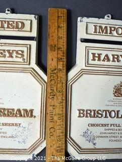 Two (2) Vintage Cast Iron Imported Harveys Bristol Cream Advertising Signs.  Each Measure 11" X 14". 