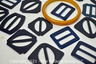 Selection of dark Bakelite and plastic women's belt buckles + one pale bangle