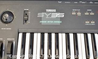 Yamaha SY-35 61-Key Keyboard with AWM/FM Synthesis and Vector Control. Includes folding stand and original box, but needs a common 12V power supply.