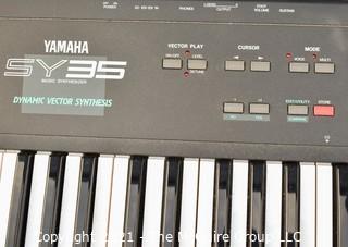 Yamaha SY-35 61-Key Keyboard with AWM/FM Synthesis and Vector Control. Includes folding stand and original box, but needs a common 12V power supply.