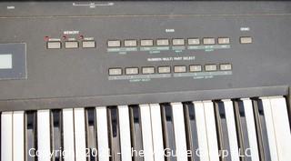 Yamaha SY-35 61-Key Keyboard with AWM/FM Synthesis and Vector Control. Includes folding stand and original box, but needs a common 12V power supply.