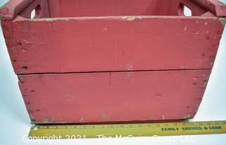 Vintage wooden bottle crate painted red.