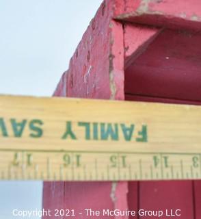 Vintage wooden bottle crate painted red.