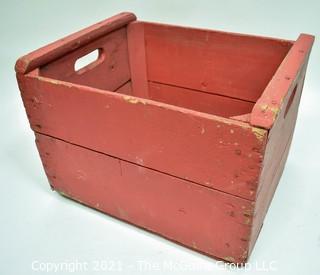 Vintage wooden bottle crate painted red.