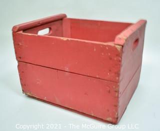 Vintage wooden bottle crate painted red.