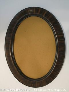 Oval wood grained frame; 19 x 25"