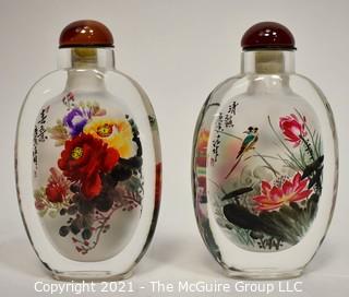 Two (2) Reverse Painted Crystal Snuff Bottles in Presentation Box with Catalog Made by Hengshui Yi-Hu-Zhai Arts & Crafts Co., China. 