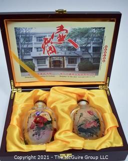 Two (2) Reverse Painted Crystal Snuff Bottles in Presentation Box with Catalog Made by Hengshui Yi-Hu-Zhai Arts & Crafts Co., China. 