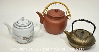 Three (3) Asian Tea Pots Made of Porcelain and Metal.