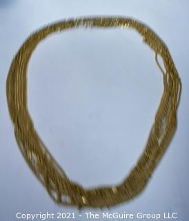 Multi-Strand Gold Tone Necklace.