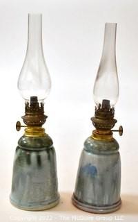 Pair of Hand Thrown Pottery Oil Lamps with Glass Shades made by Edgecomb Potters of Maine.   Each measures 14" tall with shade. 