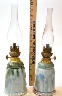 Pair of Hand Thrown Pottery Oil Lamps with Glass Shades made by Edgecomb Potters of Maine.   Each measures 14" tall with shade. 