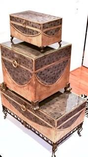 Set of Three Contemporary Decorative Trunks. Largest trunk 19D x 36W sits on 9"T metal stand. Smallest trunk measures 12 x 19" 