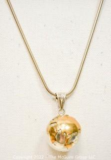 Silver & Brass World Globe Pendant with Chime Inside on Long Chain.