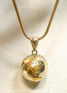 Silver & Brass World Globe Pendant with Chime Inside on Long Chain.