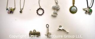 Group of Charms and Pendant Necklaces, One Sterling.  Includes Snoopy and Vintage Washington DC Souvenir Charm. 