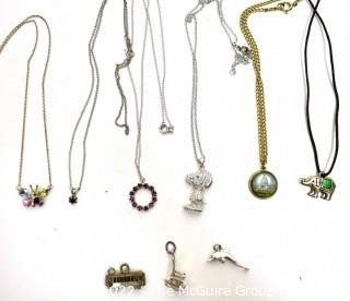 Group of Charms and Pendant Necklaces, One Sterling.  Includes Snoopy and Vintage Washington DC Souvenir Charm. 