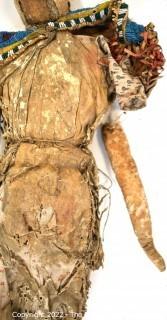 19th Century Prairie, Plains and Plateau Native American Doll, Possibly Sioux, Made of Hide and Flour Bag Muslin with Beaded Yoke.  Fabric and hide loss.  Measures 22" long. 