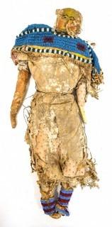 19th Century Prairie, Plains and Plateau Native American Doll, Possibly Sioux, Made of Hide and Flour Bag Muslin with Beaded Yoke.  Fabric and hide loss.  Measures 22" long. 