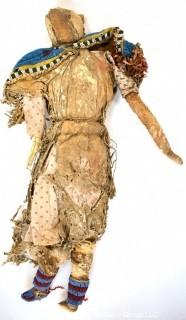 19th Century Prairie, Plains and Plateau Native American Doll, Possibly Sioux, Made of Hide and Flour Bag Muslin with Beaded Yoke.  Fabric and hide loss.  Measures 22" long. 