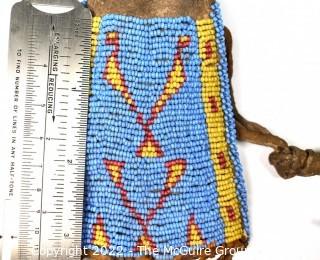 19th Century Prairie, Plains and Plateau Native American Blue, Yellow and Red Beaded Pouch with Metal Cone Shaped Bells on Edge and Rawhide Drawstring