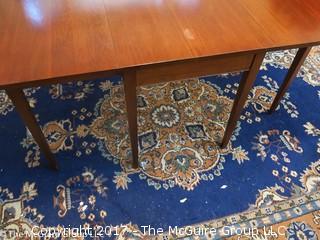 Mahogany drop leaf dining table. Collapses to fit almost anywhere, can open to fit six. Great for apartment/condo; center 24 x 48W; each leaf 24 x 48"; 30 1/2"T