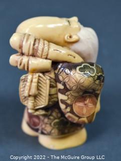 Quality Japanese Netsuke carving of one of the Seven Lucky Gods; Fukurokuju (福禄寿), who is famous for his elongated head, the immense store of wisdom he keeps in it, and his extremely old age. Fukurokuju's name is an amalgam of fuku, meaning 'happiness', roku, meaning 'wealth', and ju, which means 'longevity. Poly-chromatic colors. Signed. Composition unknown.