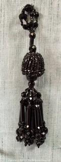 Victorian French Jet Beaded Tassel Applique Mourning Trim.  This is attached to a fabric backing but can be easily removed.  7" long