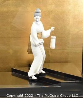 Vintage Porcelain Hand Painted White Porcelain Geisha Descending Stairs with Lantern Figurine in Glass Case with Stepped Base.  Geisha measures 16" tall.  Case measures 14" deep, 22" tall and 29" long.  Fingers have been repaired.