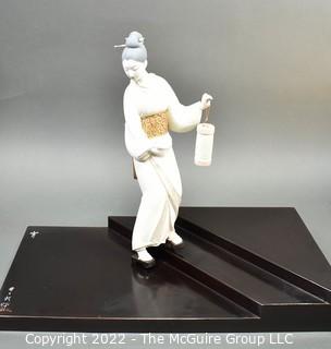 Vintage Porcelain Hand Painted White Porcelain Geisha Descending Stairs with Lantern Figurine in Glass Case with Stepped Base.  Geisha measures 16" tall.  Case measures 14" deep, 22" tall and 29" long.  Fingers have been repaired.