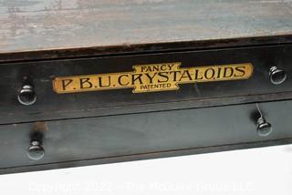 Antique Wooden Two Drawer Cabinet with Wooden Pulls. Stenciled "Fancy P.B.U. Crystaloids". Measures 16W x 16D x 6"T