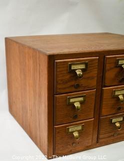 9 Drawer Oak Card Catalog filing case with watch repair contents (jewels, plates, staffs, pinoins and springs, etc.).  See all photos in the photo gallery.  Measures 20W x 17D x 13"T