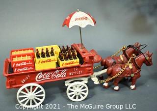 Three Decorative Items Including Coca - Cola Cast Iron Delivery Wagon With Driver, Horses and Crates, Tote Made of Bottle Caps & Wire Folk Art World Globe.