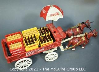 Three Decorative Items Including Coca - Cola Cast Iron Delivery Wagon With Driver, Horses and Crates, Tote Made of Bottle Caps & Wire Folk Art World Globe.