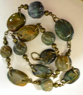 One (1) Strand Shaped Agate Beads with Bronze Fittings.  Measures 20".